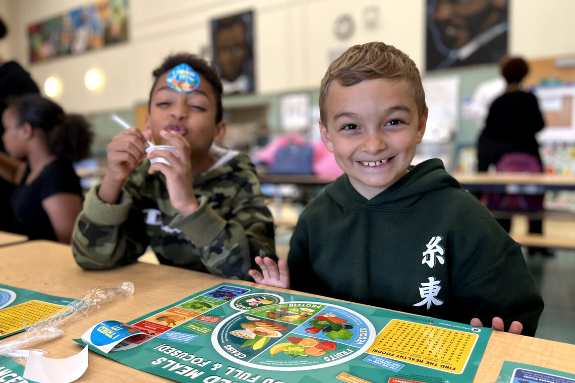 two boys enjoying school lunch