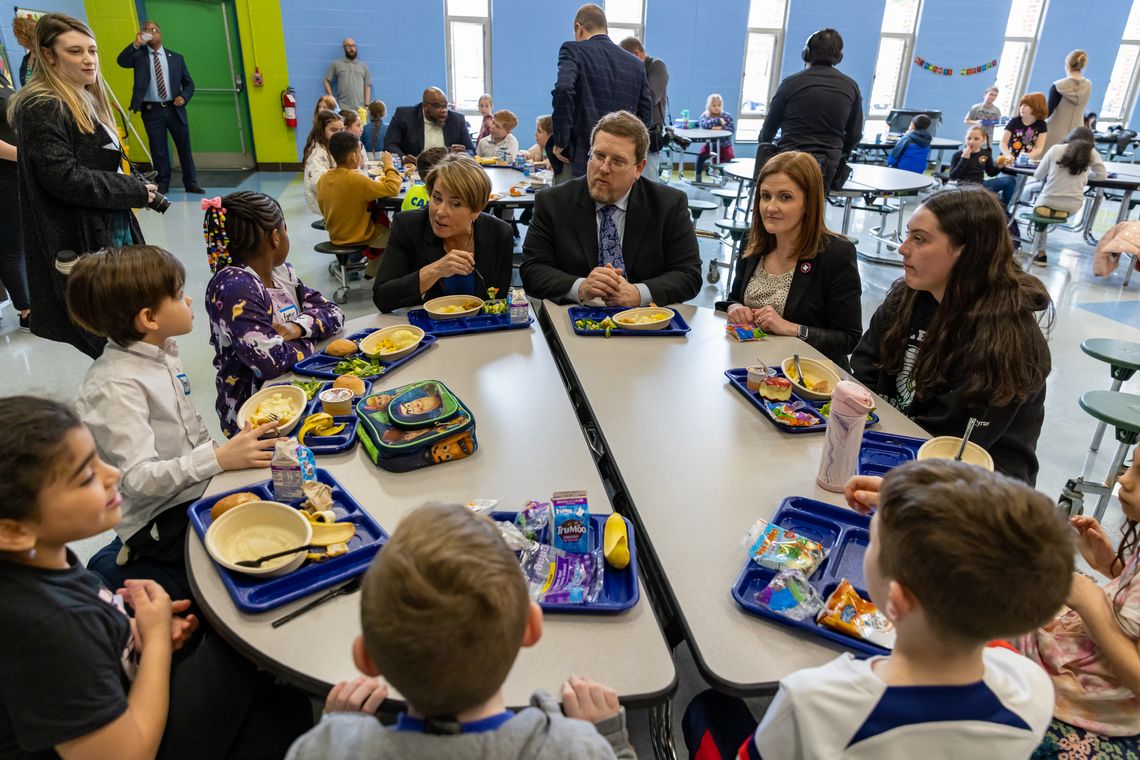Gov Healey, Superintendent , Jen Lemmerman sit with students